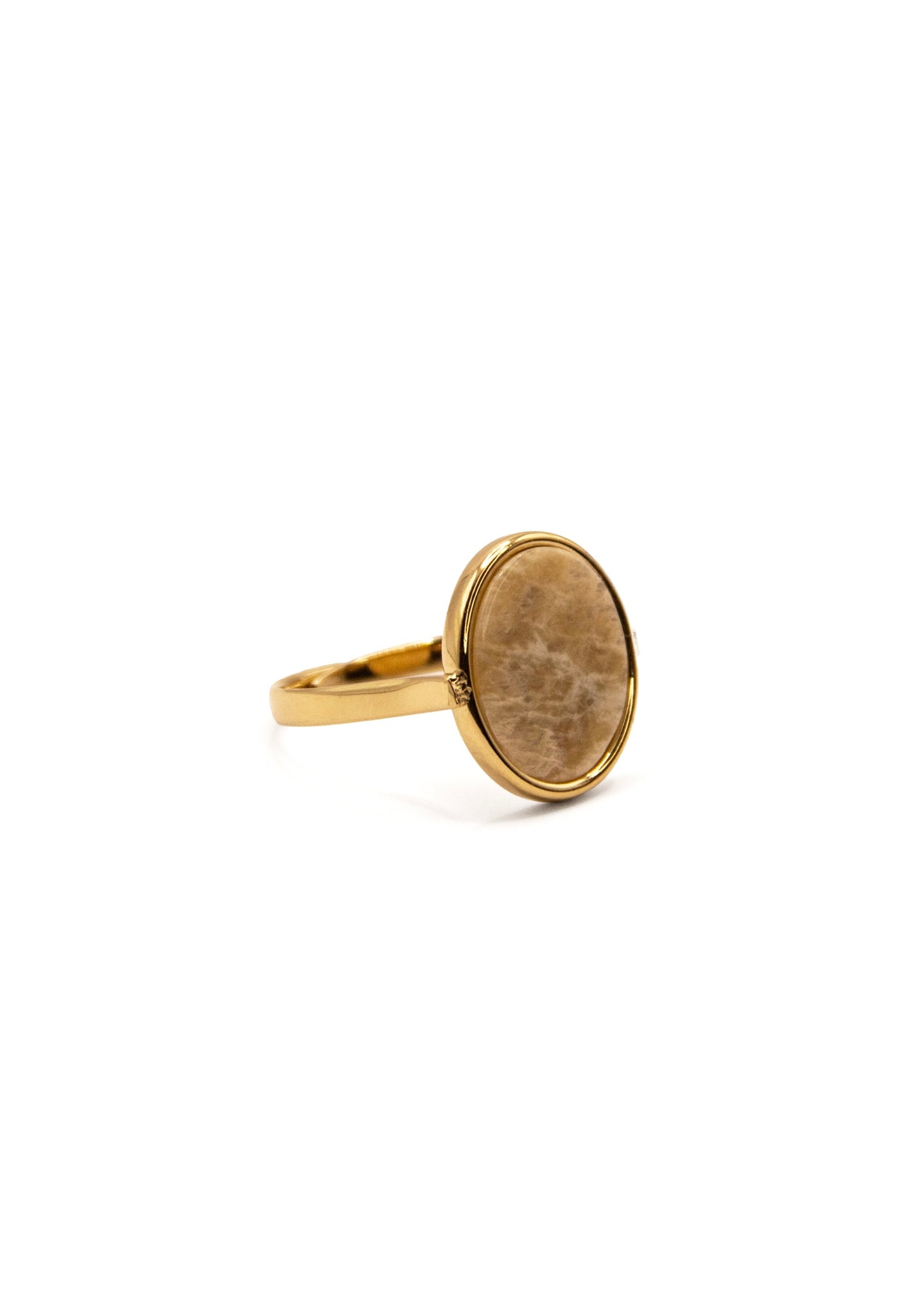 Anello ovale in acciaio placcato oro con pietra dura naturale. Fascia sottile e regolabile, montatura liscia che avvolge la pietra. Disponibile in diversi colori, dal design elegante e raffinato. pietra beige