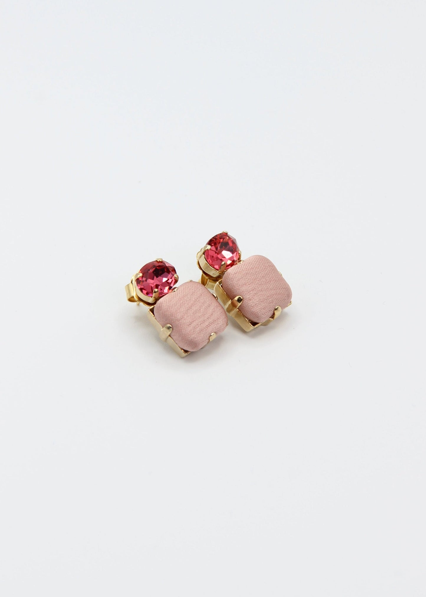 Orecchini rosa eleganti fatti a mano da Laura Sciunnach Bijoux, modello Metropolitan Siviglia con bottone quadrato in stoffa rosa cipria e cristallo ovale rosa ciclamino, design geometrico leggero e raffinato.