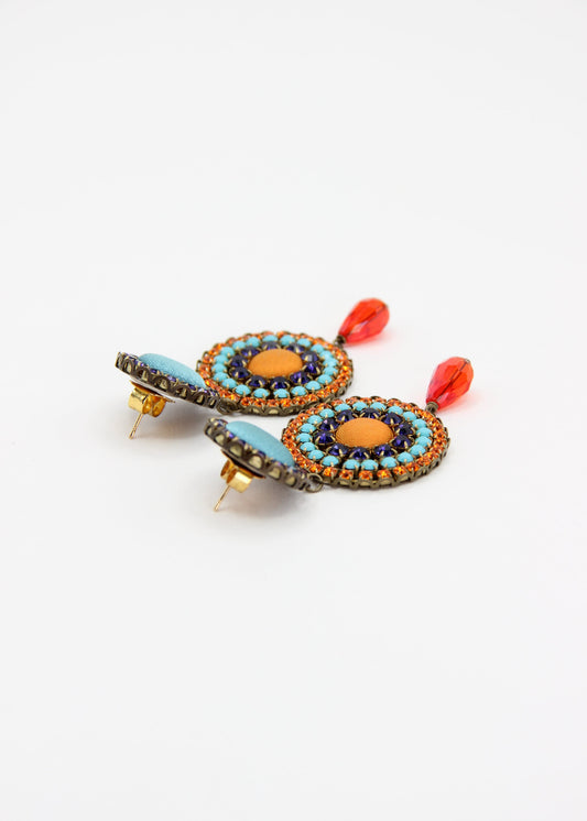 Orecchini artigianali Metropolitan Dubai blu e arancione, con bottoni circolari in tessuto azzurro, cristalli in gradiente blu, arancione e azzurro e pendente a goccia in cristallo. Nickel free, ideali per cerimonie ed eventi speciali.